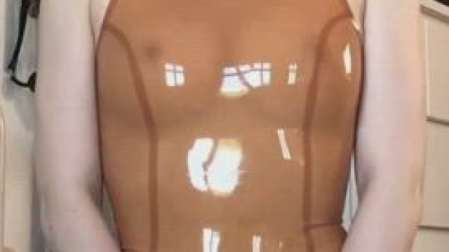 Unzipping her latex one piece to flash her pussy